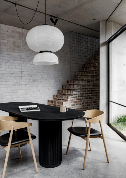 Underline Table – sculptural dining table in Black Oak with hollow cylindrical bases