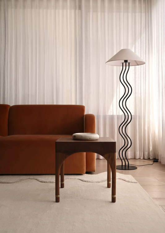 Wela Side Table Baan Collection – sculptural side table embodying fluidity in walnut
