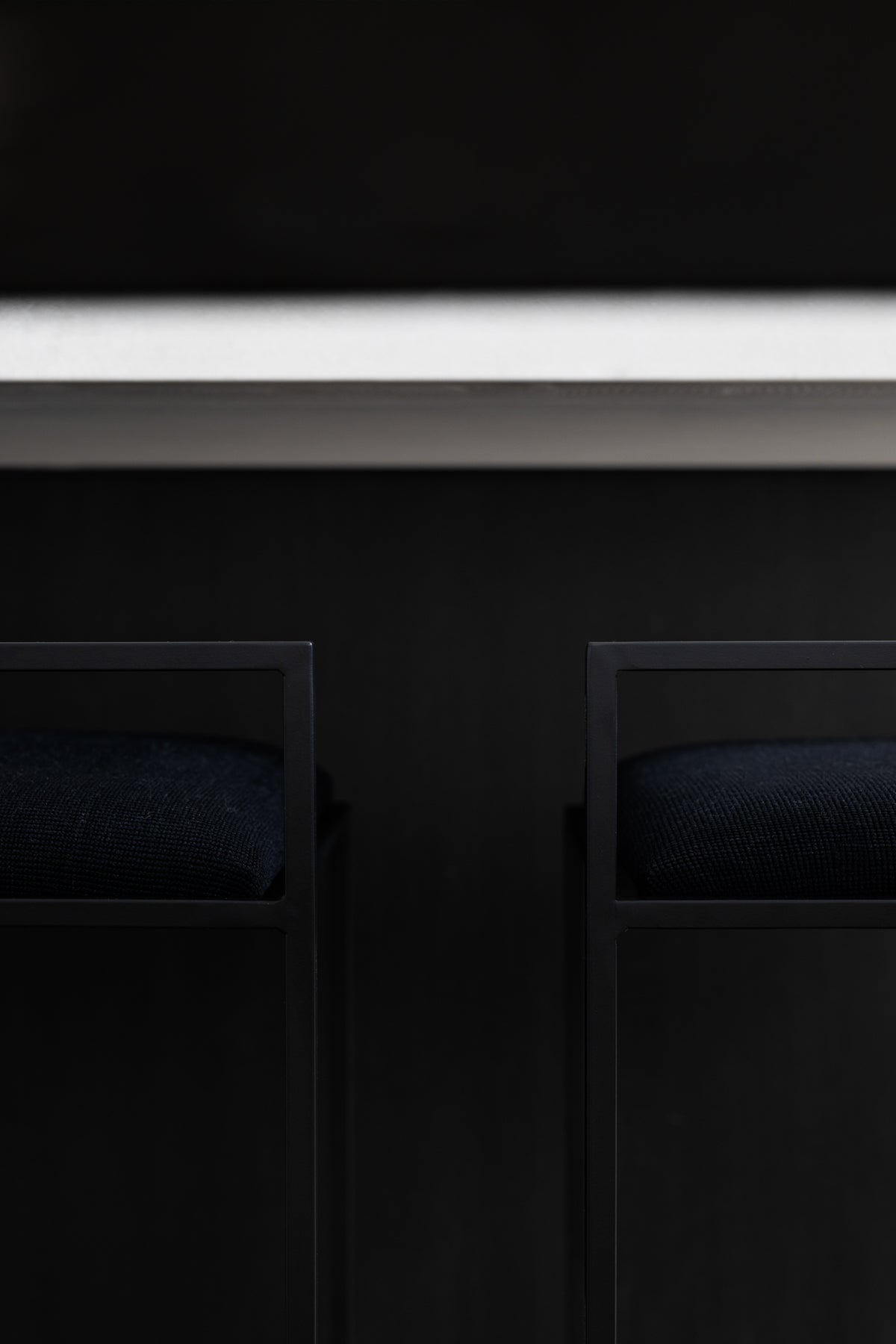 Kolsai Stool side view showing black fabric and black powder coat