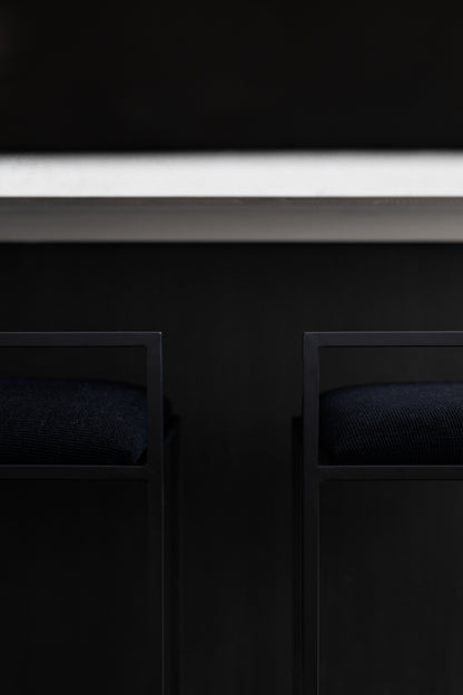 Kolsai Stool side view showing black fabric and black powder coat